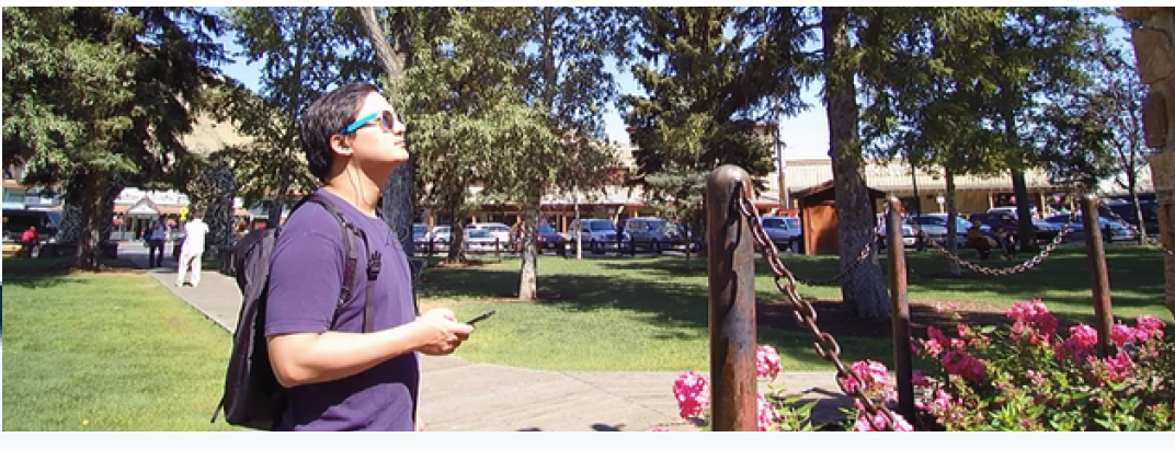Woman with headphones in car looking at scenic landscape